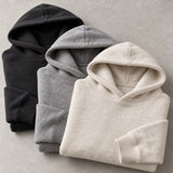 Illustrative black grey and cream fleece hoodies